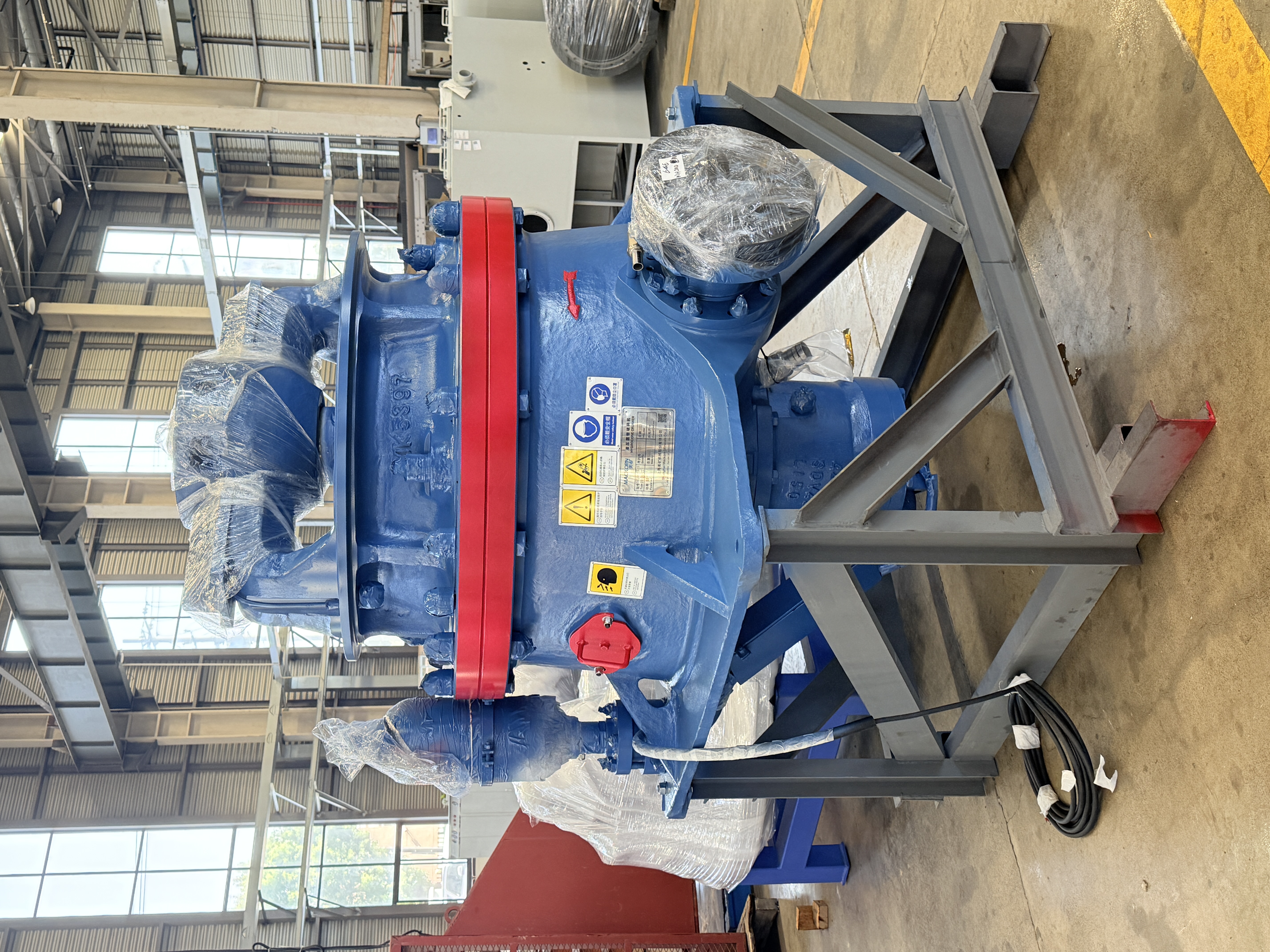 Hydraulic cone crusher on a steel support stand
